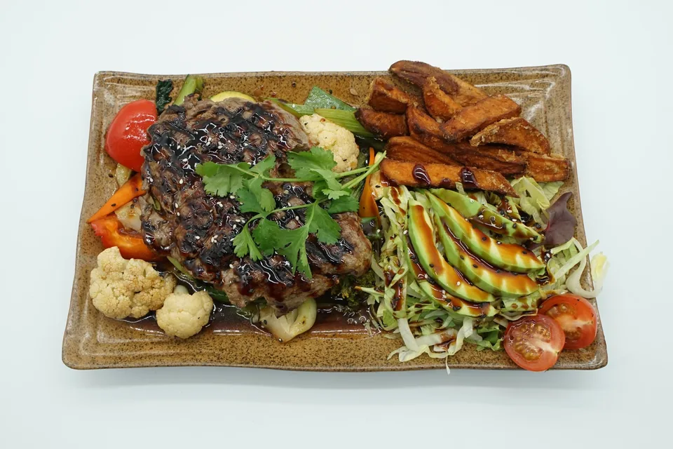 Korean BBQ steak with vegetables, sweet potatoes and salad