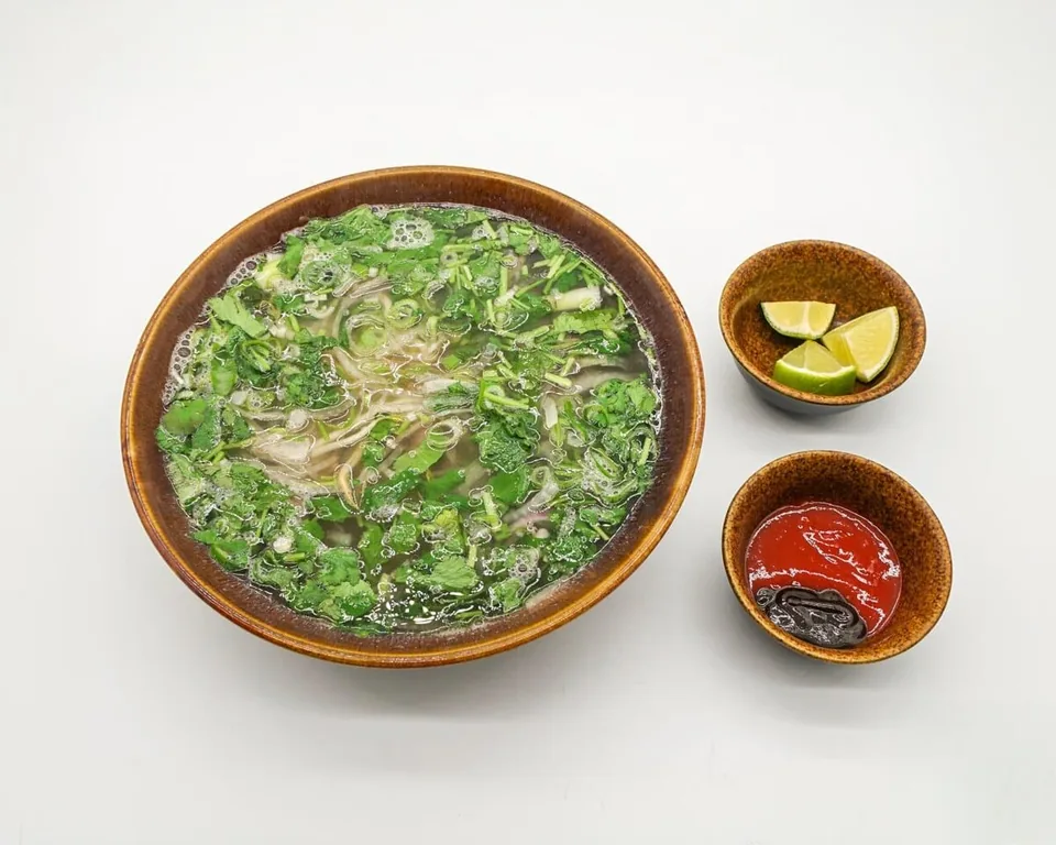 Pho with fresh herbs and lime